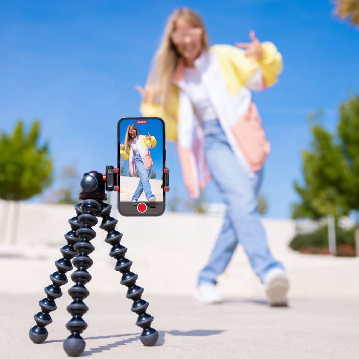 Teenage girl filming TikTok video of herself on mobile phone